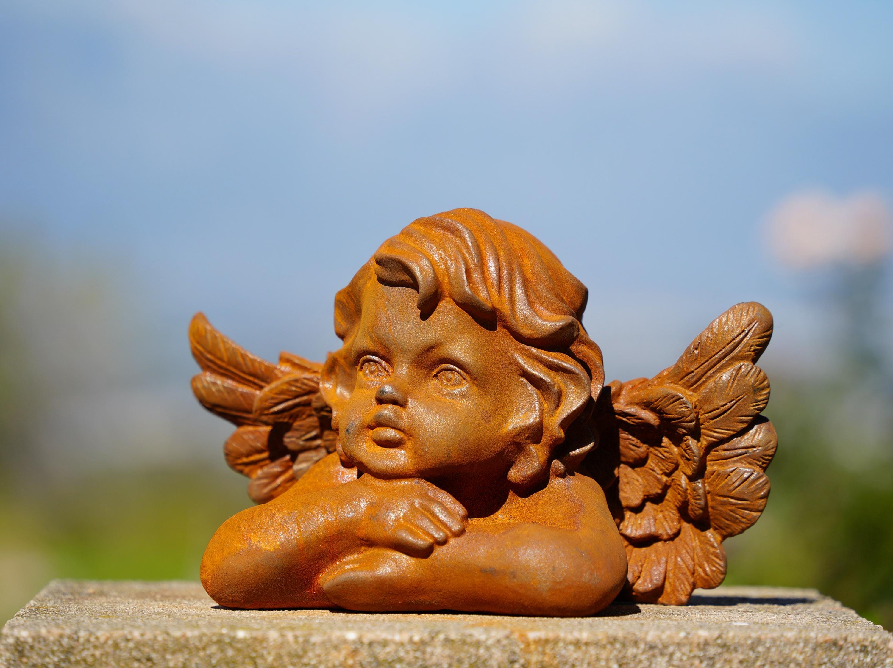 Cast Iron Dreaming Angel Sculpture: Rustic Garden Decor