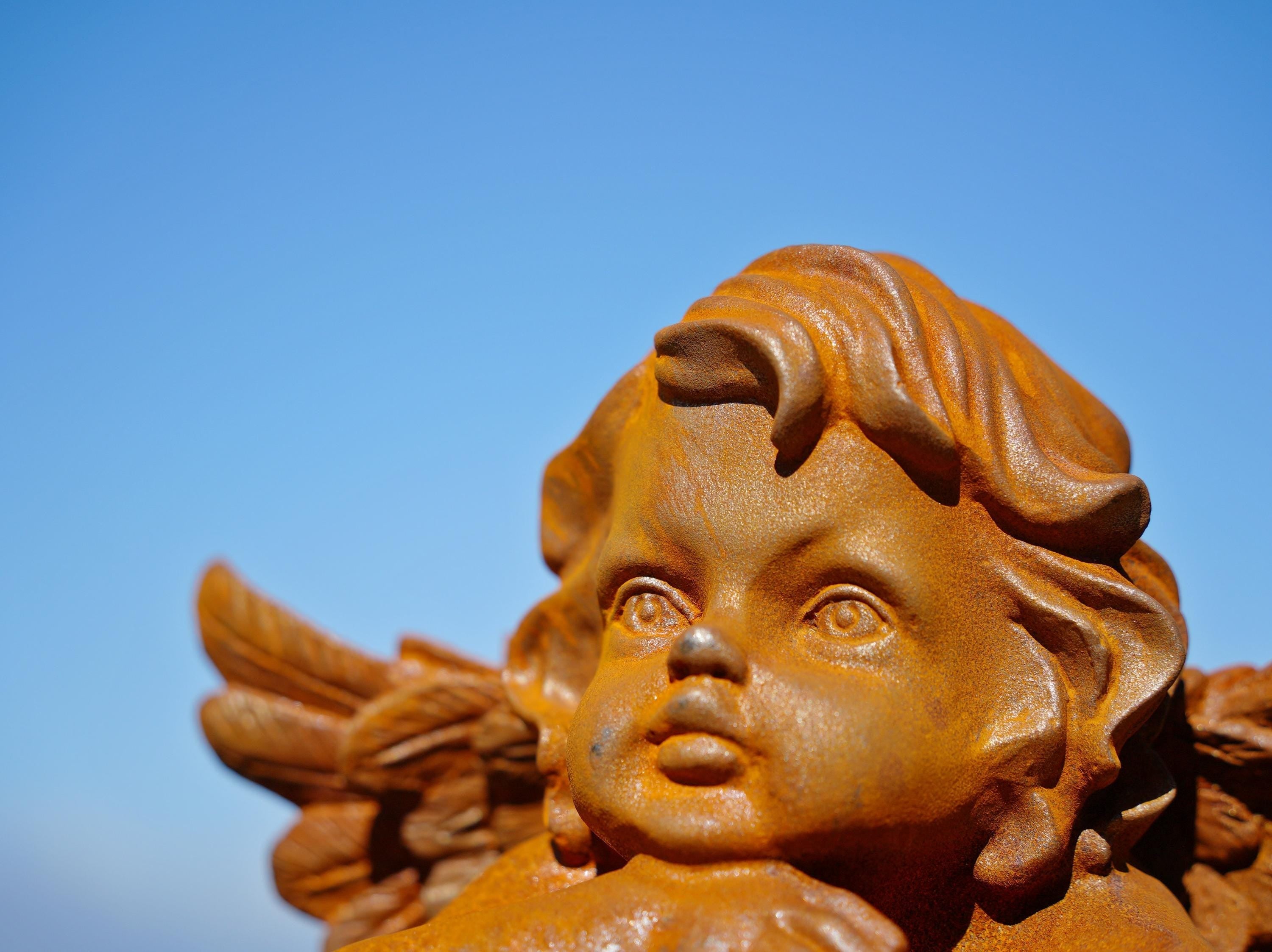 Cast Iron Dreaming Angel Sculpture: Rustic Garden Decor