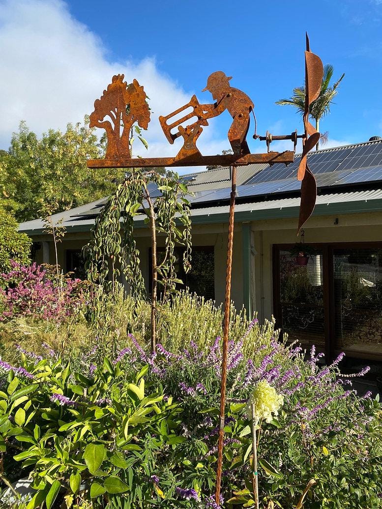 Rusty Lumberjack Wind Spinner — Kinetic Wind-Powered Metal Garden Sculpture