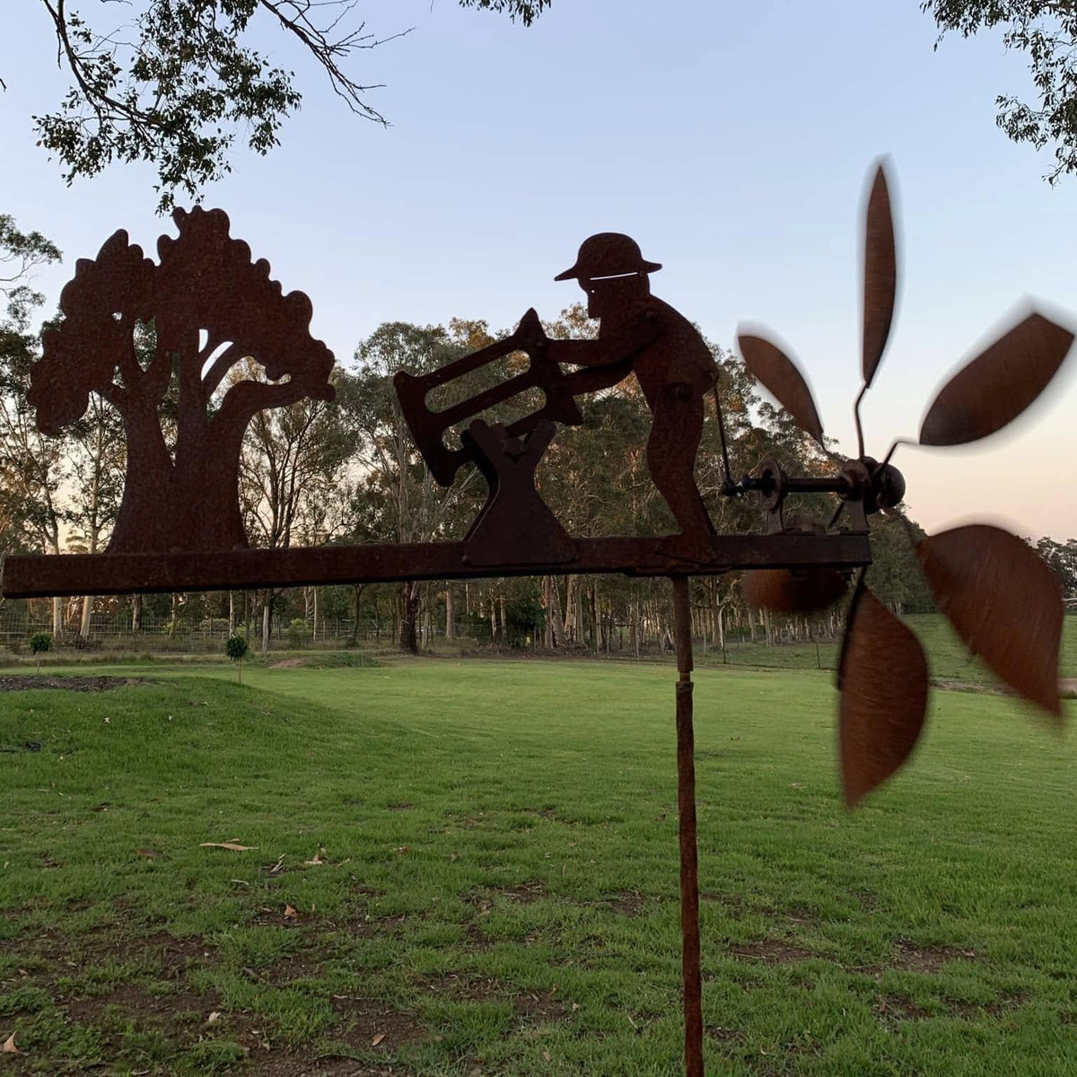 Rusty Lumberjack Wind Spinner — Kinetic Wind-Powered Metal Garden Sculpture